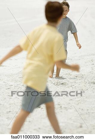 Boys playing on beach View Large Photo Image Stock Image - Boys playing on beach. Fotosearch