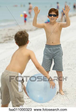 Boys playing with ball on beach View Large Photo Image Stock Image - Boys playing with ball on beach. Fotosearch