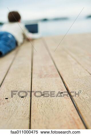 Child lying on dock View Large Photo Image Stock Photography - Child lying on dock. Fotosearch