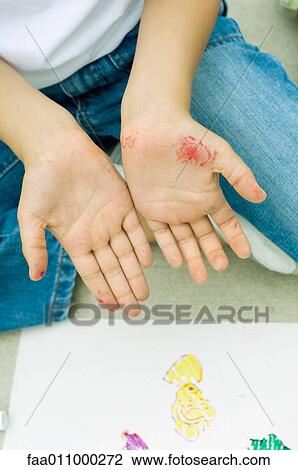 Stock Image - Child showing hands dirty with marker, close-up. Fotosearch