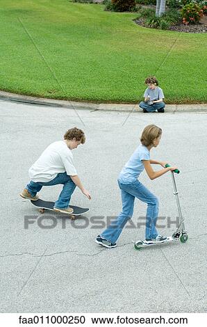 Stock Image - Children playing in suburban street. Fotosearch