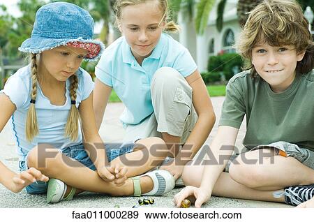 Children playing marbles in residential street View Large Photo Image Stock Photo - Children playing marbles in residential street. Fotosearch