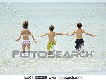 Children running in surf together View Large Photo Image Stock Photograph - Children running in surf together. Fotosearch