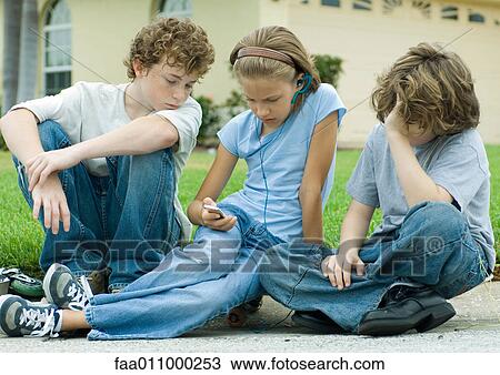 Children sitting in street, one with mp3 player View Large Photo Image Stock Image - Children sitting in street, one with mp3 player. Fotosearch