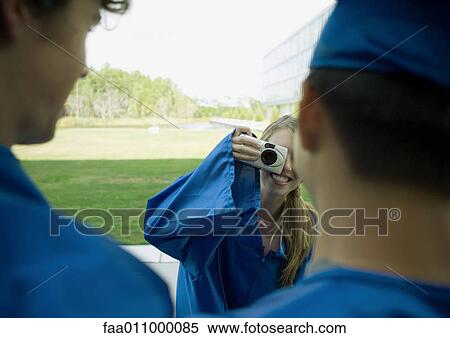 Female graduate taking photo of friends View Large Photo Image Stock Photography - Female graduate taking photo of friends. Fotosearch