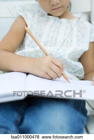 Girl drawing in notebook View Large Photo Image Stock Photo - Girl drawing in notebook. Fotosearch