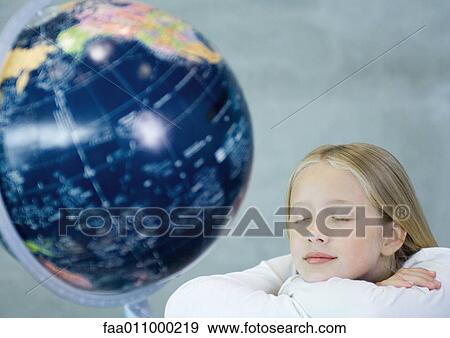 Girl dreaming near globe View Large Photo Image Stock Photo - Girl dreaming near globe. Fotosearch