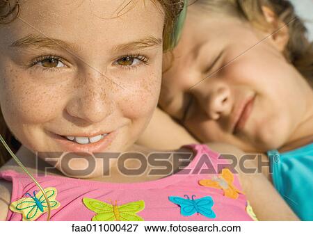 Girl in bathing suit, friend sleeping in background View Large Photo Image Stock Photo - Girl in bathing suit, friend sleeping in background. Fotosearch