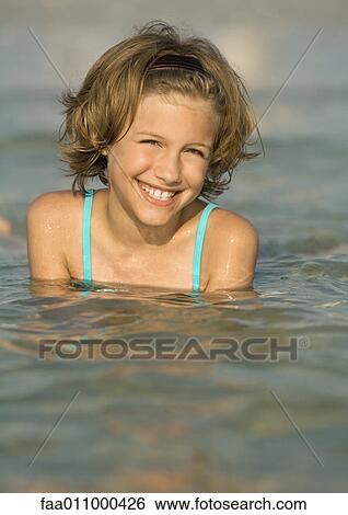 Girl in ocean, smiling View Large Photo Image Stock Photograph - Girl in ocean, smiling. Fotosearch