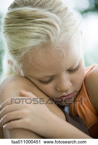 Girl leaning head against knee View Large Photo Image Stock Image - Girl leaning head against knee. Fotosearch