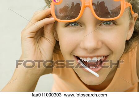 Girl lifting sunglasses View Large Photo Image Stock Image - Girl lifting sunglasses. Fotosearch