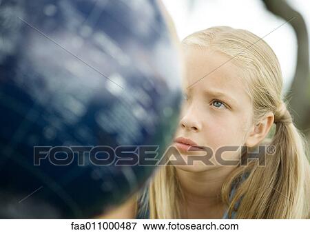 Girl looking at globe View Large Photo Image Stock Photo - Girl looking at globe. Fotosearch