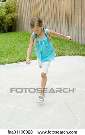 Girl playing hopscotch View Large Photo Image Stock Image - Girl playing hopscotch. Fotosearch