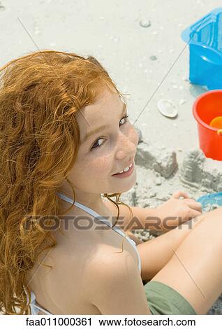 Girl playing in sand on beach View Large Photo Image Stock Image - Girl playing in sand on beach. Fotosearch