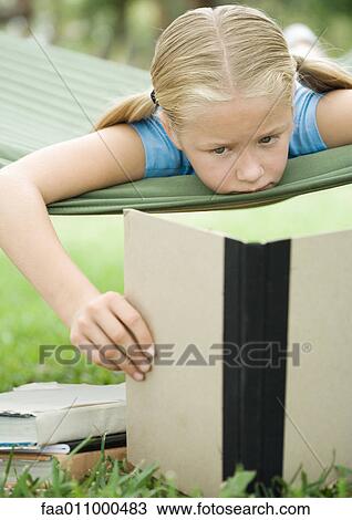Girl reading book on hammock View Large Photo Image Stock Image - Girl reading book on hammock. Fotosearch