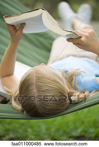Girl reading book on hammock View Large Photo Image Stock Photography - Girl reading book on hammock. Fotosearch