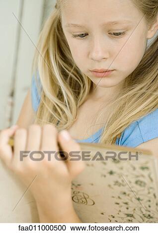 Stock Image - Girl reading book. Fotosearch