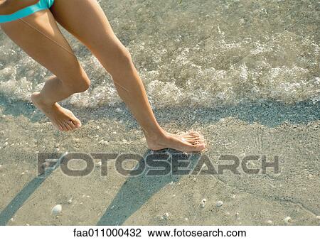 Girl running in surf, low section View Large Photo Image Stock Image - Girl running in surf, low section. Fotosearch