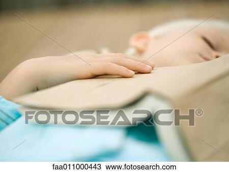 Girl sleeping with book on chest View Large Photo Image Stock Image - Girl sleeping with book on chest. Fotosearch