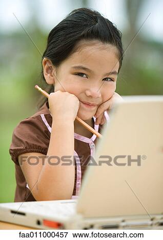 Girl using laptop, smiling View Large Photo Image Stock Photo - Girl using laptop, smiling. Fotosearch