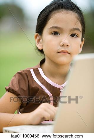Stock Photograph - Girl using laptop. Fotosearch