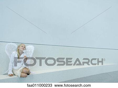 Girl wearing angel wings and holding wand View Large Photo Image Stock Image - Girl wearing angel wings and holding wand. Fotosearch