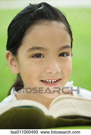 Stock Image - Girl with book, portrait. Fotosearch