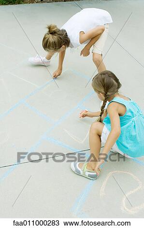 Girls drawing hopscotch game on driveway View Large Photo Image Stock Image - Girls drawing hopscotch game on driveway. Fotosearch