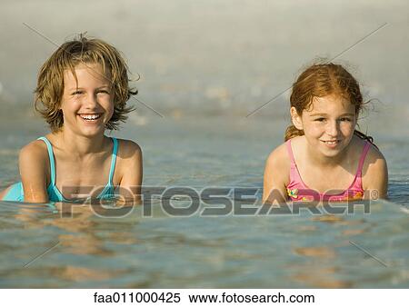 Girls in ocean, smiling View Large Photo Image Stock Photography - Girls in ocean, smiling. Fotosearch