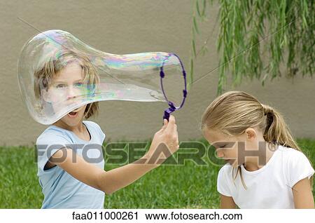 Girls making bubbles View Large Photo Image Stock Image - Girls making bubbles. Fotosearch