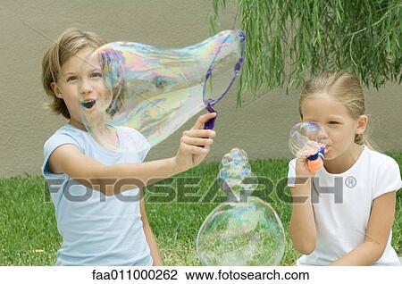 Girls making bubbles View Large Photo Image Stock Image - Girls making bubbles. Fotosearch