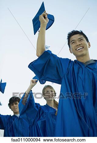 Graduates taking off caps View Large Photo Image Picture - Graduates taking off caps. Fotosearch