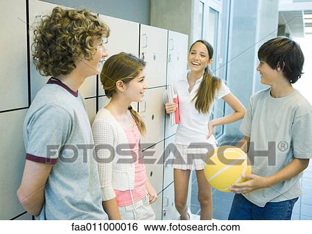 Group of young teens standing together near school lockers View Large Photo Image Stock Photograph - Group of young teens standing together near school lockers. Fotosearch