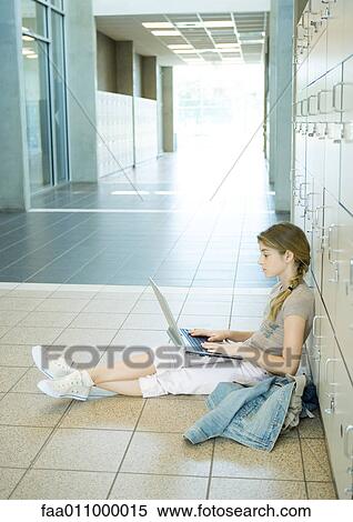 High school girl using laptop in school hallway View Large Photo Image Stock Photography - High school girl using laptop in school hallway. Fotosearch