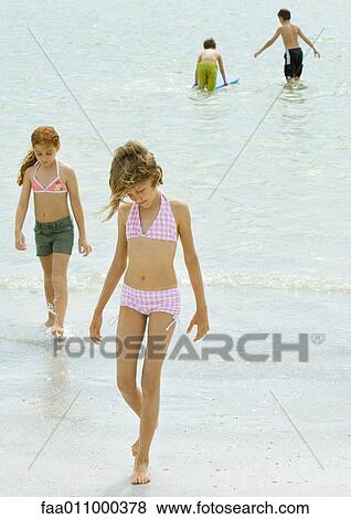 Kids playing on the beach View Large Photo Image Stock Photo - Kids playing on the beach. Fotosearch