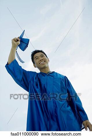 Male graduate taking off cap View Large Photo Image Stock Image - Male graduate taking off cap. Fotosearch
