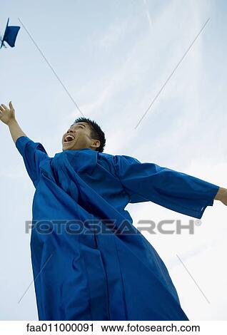 Male graduate throwing cap View Large Photo Image Stock Image - Male graduate throwing cap. Fotosearch