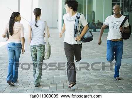 Male students running across campus, looking back at female students View Large Photo Image Stock Photo - Male students running across campus, looking back at female students. Fotosearch
