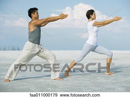Man and woman stretching on beach View Large Photo Image Stock Photo - Man and woman stretching on beach. Fotosearch