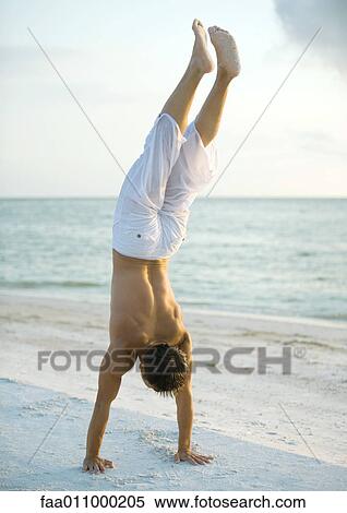 Man doing handstand on beach View Large Photo Image Stock Photography - Man doing handstand on beach. Fotosearch