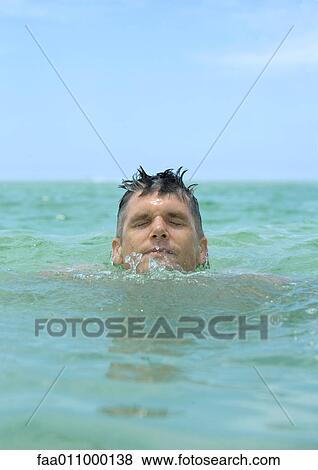 Man emerging from water View Large Photo Image Stock Photo - Man emerging from water. Fotosearch