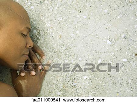 Man lying in surf, high angle view View Large Photo Image Stock Image - Man lying in surf, high angle view. Fotosearch