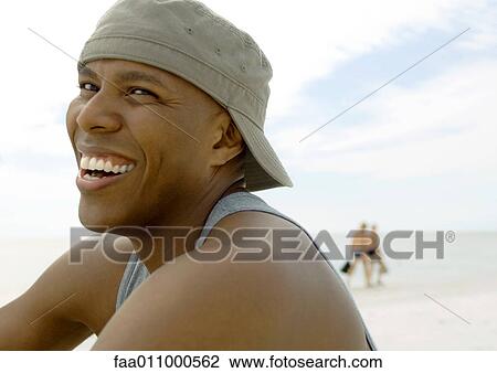 Man on beach, laughing View Large Photo Image Stock Image - Man on beach, laughing. Fotosearch
