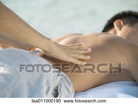 Stock Image - Man receiving back massage. Fotosearch