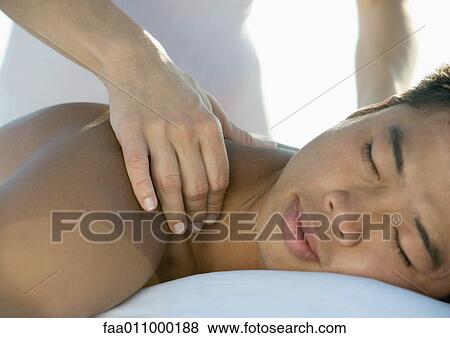 Man receiving back massage View Large Photo Image Stock Photo - Man receiving back massage. Fotosearch