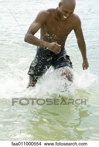 Man splashing in water View Large Photo Image Picture - Man splashing in water. Fotosearch