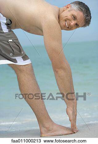 Stock Image - Man touching toes. Fotosearch
