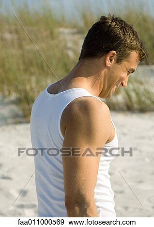 Man wearing tank top, dune in background View Large Photo Image Stock Photo - Man wearing tank top, dune in background. Fotosearch