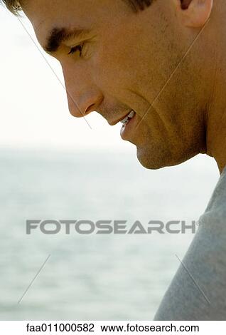 Man's face, sea in background View Large Photo Image Stock Image - Man's face, sea in background. Fotosearch