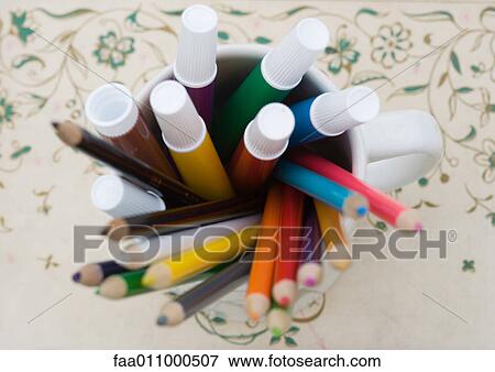 Mug full of colored pencils and markers, high angle view View Large Photo Image Stock Photo - Mug full of colored pencils and markers, high angle view. Fotosearch